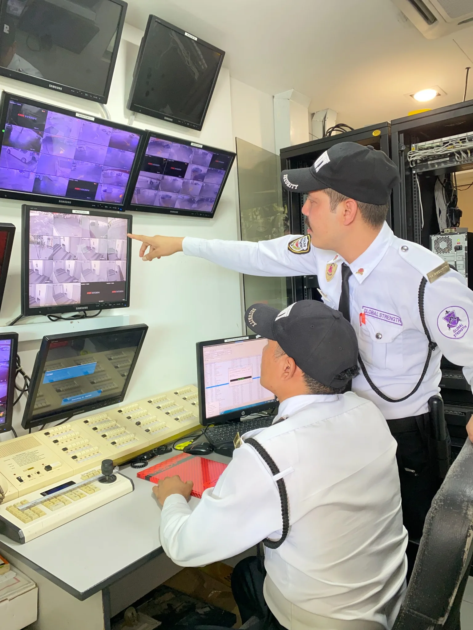 Security personnel monitoring CCTV systems