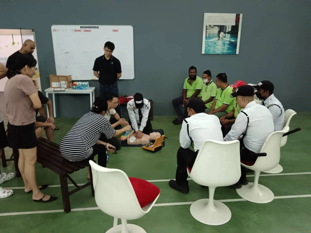 Security guard performing CPR practice during training